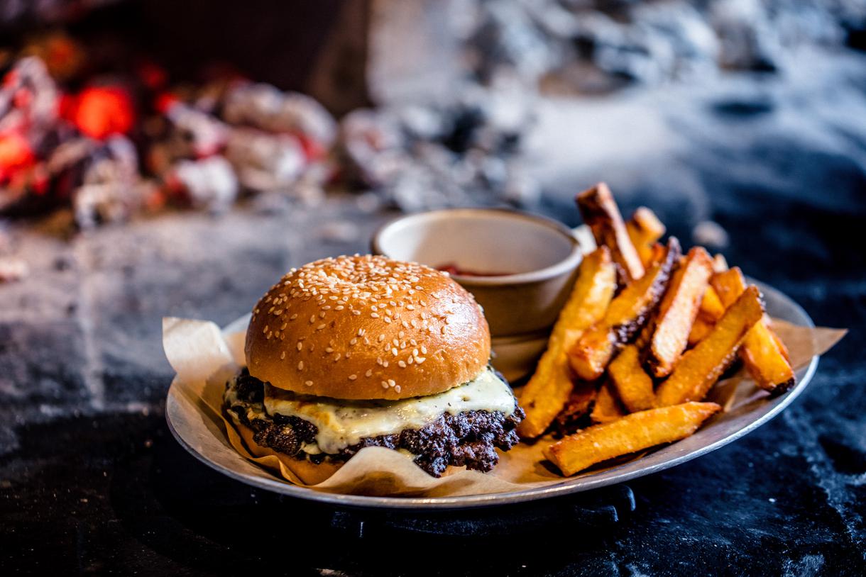 The juicy cheeseburger is accompanied by perfectly crispy fries.