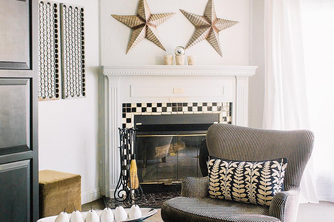 Cozy up by the fireplace in a rustic-chic guest room.