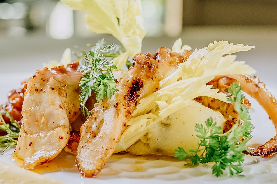 Enjoy fresh seafood dishes such as grilled octopus with green papaya salad.