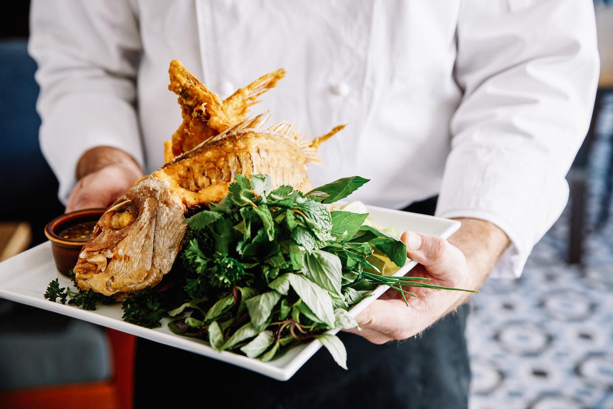 The whole crispy fish is served alongside a delicious green papaya salad.