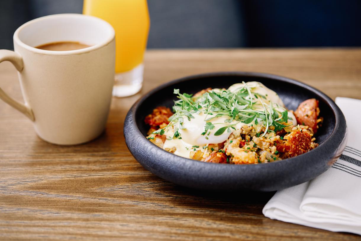 The signature hash benny is loaded with Lao sausage, potatoes, and poached eggs.