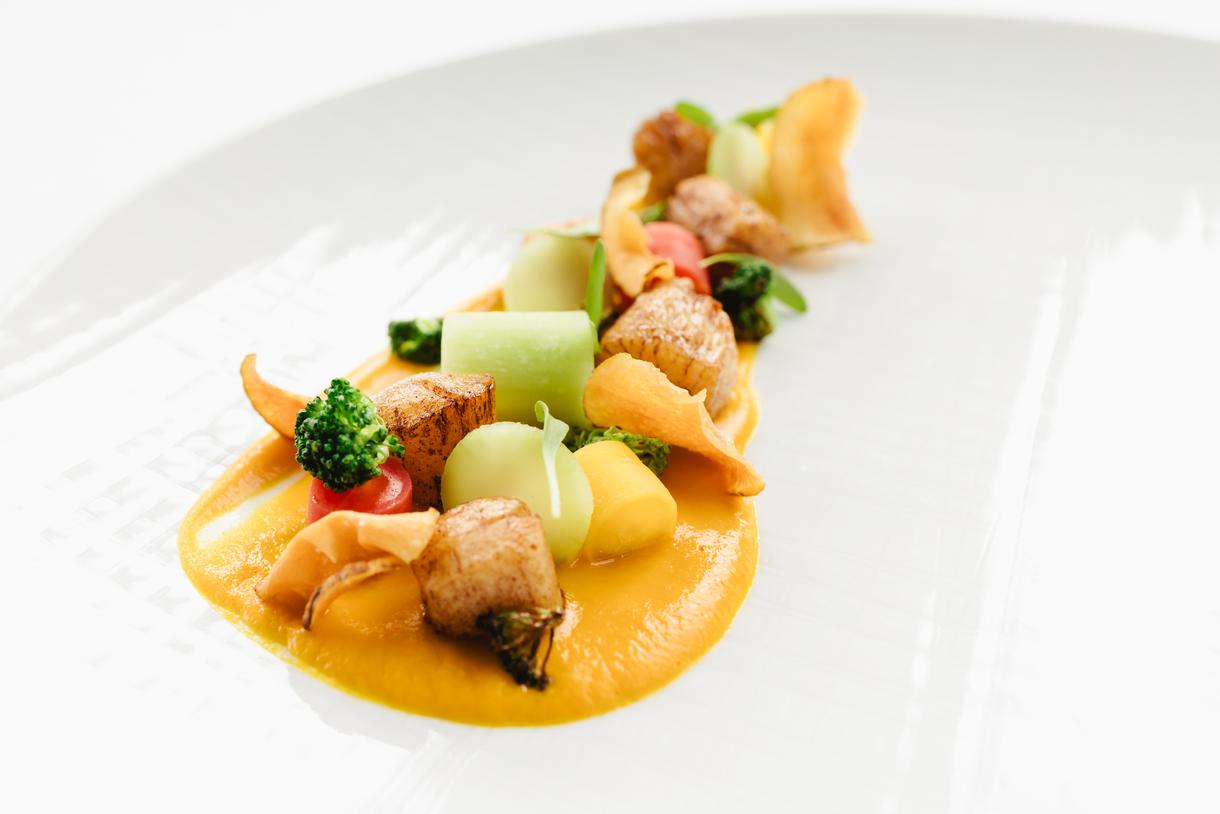 A medley of Martha's Vineyard scallops, broccoli, carrots, and a kaffir lime-infused sauce.