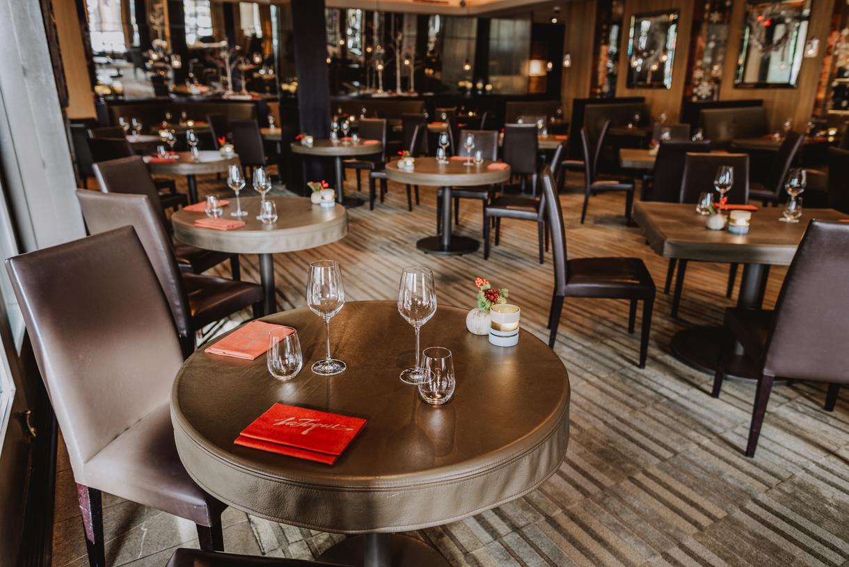 Plush chairs and leather-topped tables set the tone.